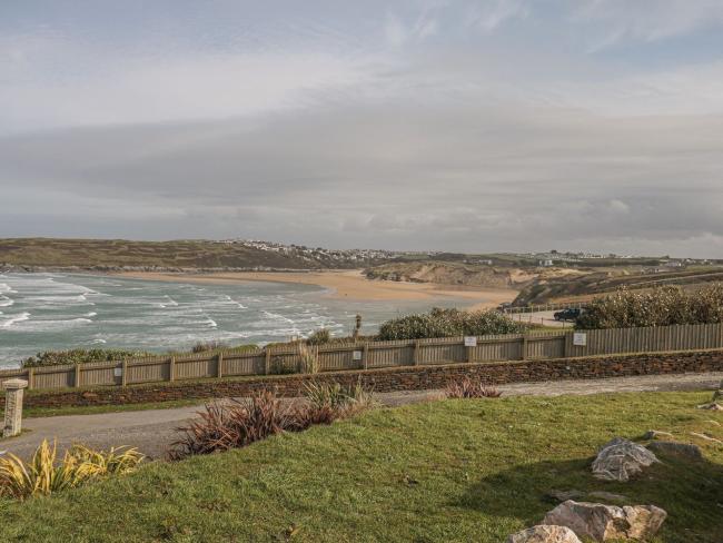 Crantock Beach in Cornwall A Cornish landscape view looking across open fields, sand dunes to the sandy surfing beach at Crantock