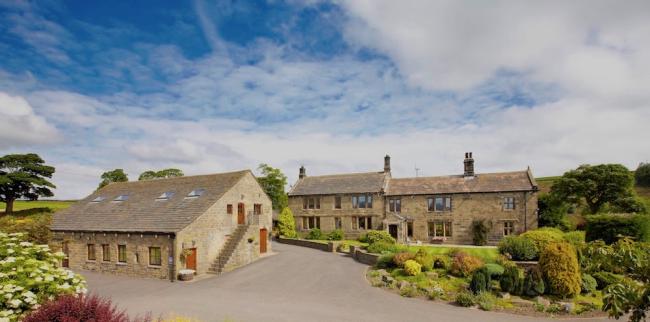 Smallshaw Farm Cottages in Penistone. farmhouse and out-buildings surrounded by mature gardens.