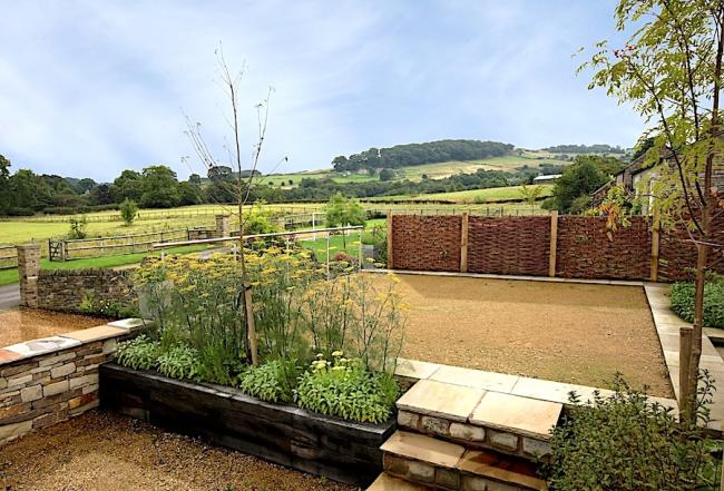 Find Rural Holiday Cottages in Rainow A garden with shingle beds with far-reaching Cheshire views of fields and trees.