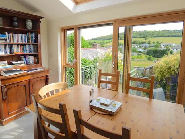 Enjoy the Peaceful Rural Views From Your Allithwaite Holiday Cottage A rural view as seen through the windows from a dining room table.