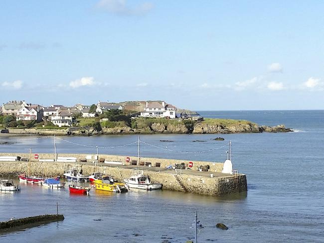 Discover the dramatic beauty of the Anglesey coast and beaches A small fishing harbour with moored boats.