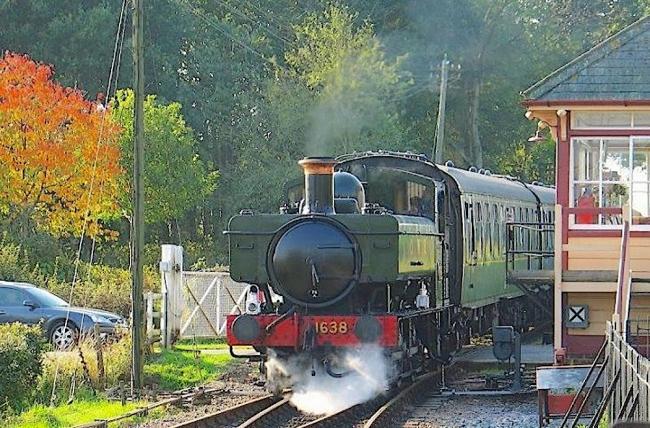 Enjoy self-catering holidays in Wittersham A pannier tank steam engine heads a train through s level crossing in Wittersham
