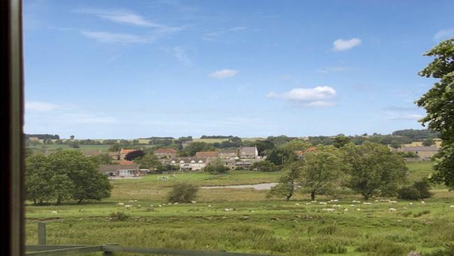 Ravensworth Holiday Cottages A cluster of small village cottages surrounded by fieelds and trees