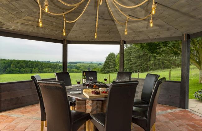 Find Somewhere Amazing to Eat in on a Worcestershire Cottage Holiday. Photo credit: Broad Meadows Farmhouse A table for eight beneath a pergola with far-reaching rural views.