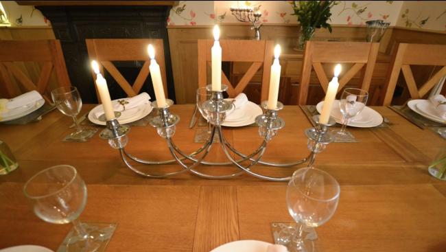 View Derwent House Discounts - Large Peak District Holiday Cottage 5 brightly burning candles on a table candelabra.