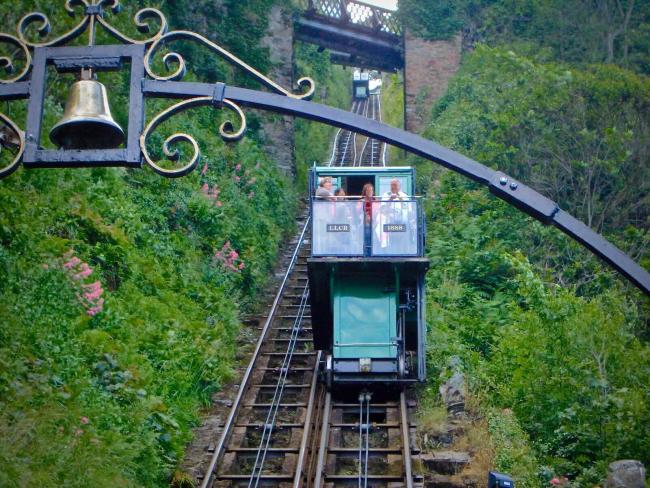The Quck and Easy Way to the Beach and Harbour From Lynton. A carriage on a cliff railway ascended its steep track.