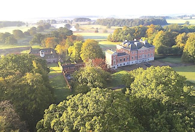 The Treasury in Aylsham on the Norfolk Coast. Aerial view of 3-storey, Norfolk country house and its wooded estate in Norfolk.