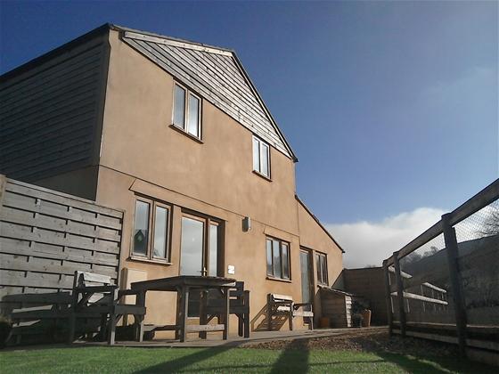 A 2-storey Dorset mill conversion overlooks a terrace and lawned garden.