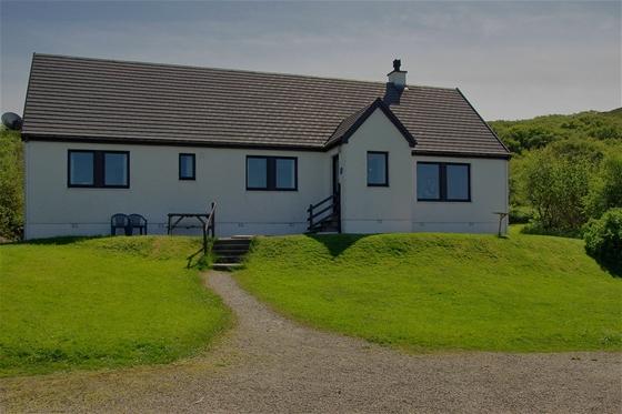 A secluded holiday bungalow surrounded by lawns in the Scottish countryside.