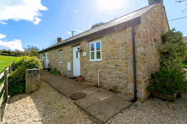 Stone-built, single storey barn conversion overlooking open countryside.