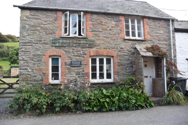 Exterior of a stone-built riverside cottage on Exmoor