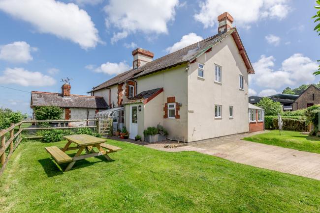 Exterior of a 1930s Dorset house and garden in Dorset with a large lawn