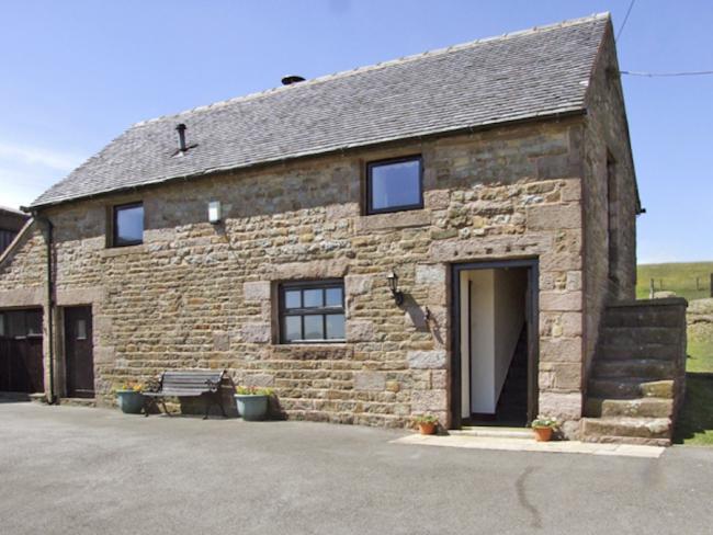 2-storey exterior of a stone-built Peak District holiday cottage in a remote rural location.