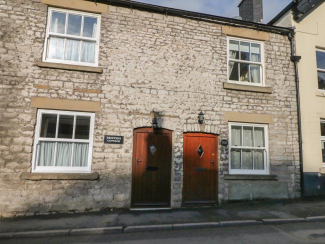 Double-fronted exterior of a stone-built holiday cottage in Buxton