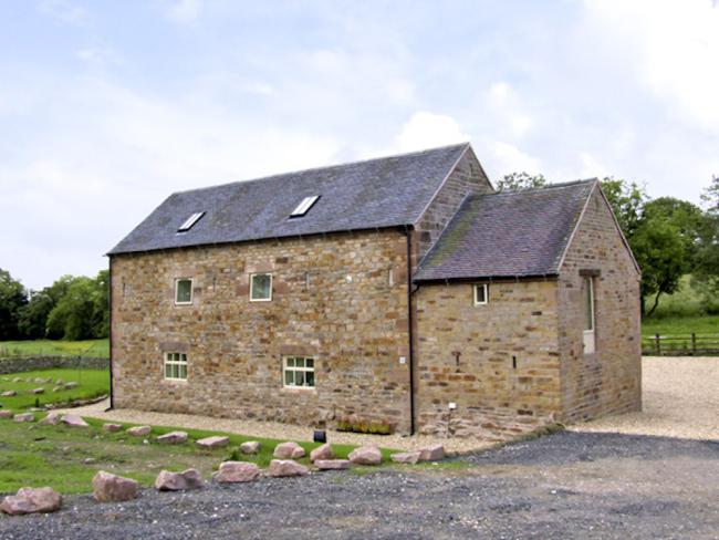 Exterior of a 2-storey, stone-built,  barn conversion in a rural Peak District location.