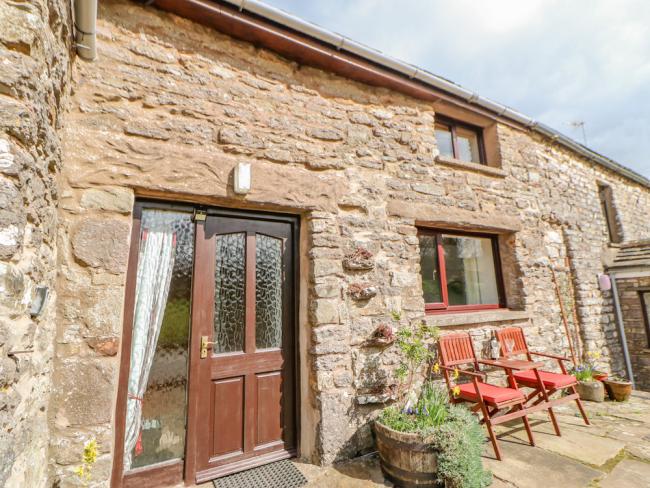 A 2-storey, stone-built holiday cottage in Cumbria overlooking a sunny courtyard