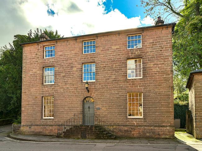 A 3-storey Georgian house with sash windows.