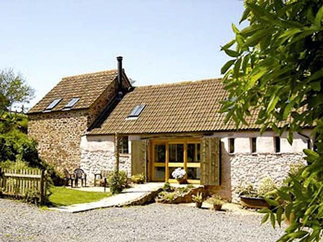 A barn conversion in Bicknoller overlooks a tree-fringed courtyard