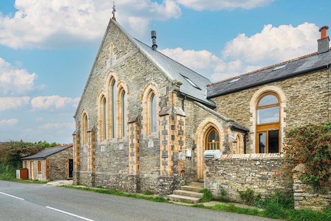 Chapel conversion exterior with tall arched windows near Polruan
