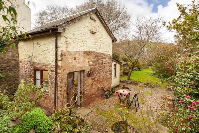 A small stone-built Quantock Hills barn conversion surrounded by gardens.