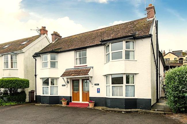 Exterior of a 2-bedroom, semi-detached holiday home with parking spaces.