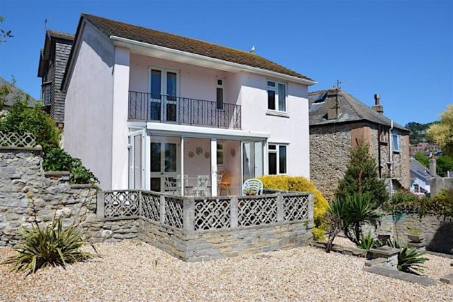 Exterior of a modern detached house with covered balcony.