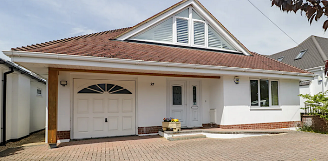Exterior of a modern chalet bungalow with block-paved drive.