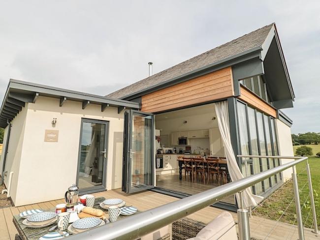 Contemporary wood and glass bungalow with floor to ceiling French windows