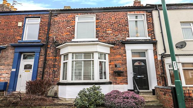 2-storey Victorian town house with bay windows and small front garden