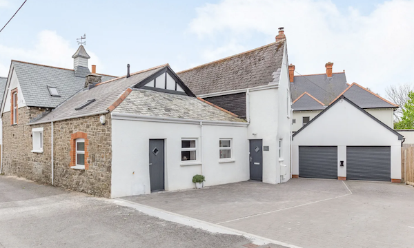 Exterior of a converted Devon coach house with a double garage