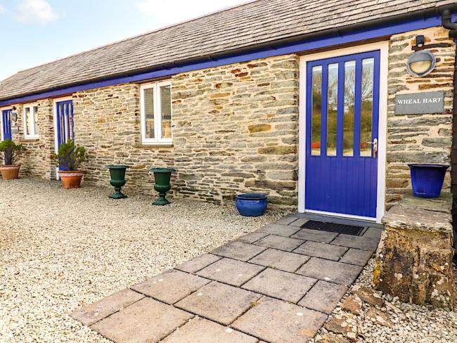Exterior of a single-storey Cornish stone barn conversion.