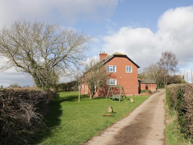A drive leads to a brick-built Herefordshire country cottage.