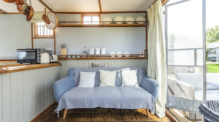 Open-plan living space in a converted horse box in Somerset.