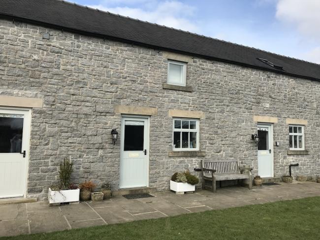 Exterior of stone-built, barn conversion in the Peak District.