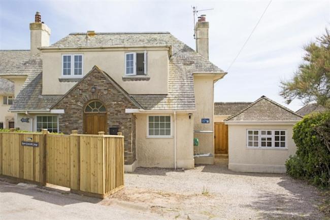 Front exterior of a 2-storey holiday home in Thurlestone with a wide drive for parking.