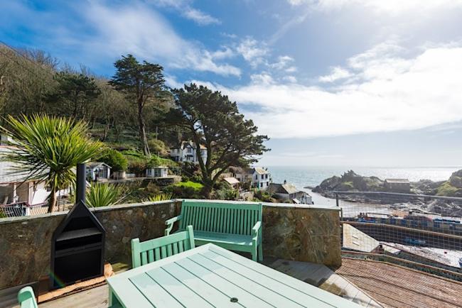 The harbour and sea view from the deck of a Polperro holiday cottage.