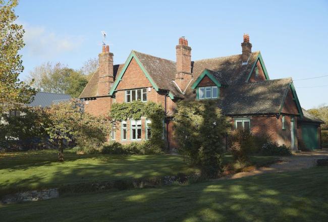A large brick-built country house and gardens in Herefordshire.