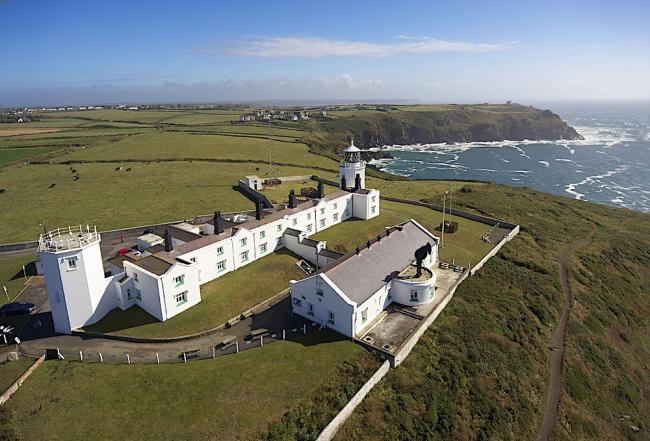A lighthouse complex on a rugged clifftop in Cornwall.