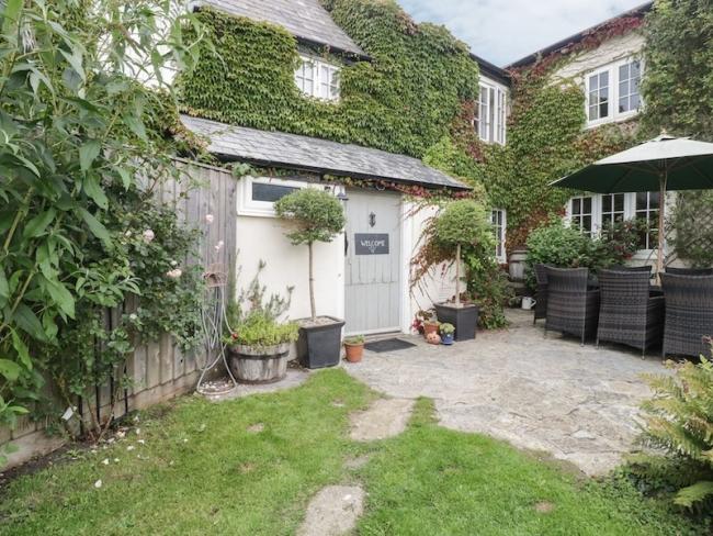 Exterior of a vine-covered Somerset farmhouse.