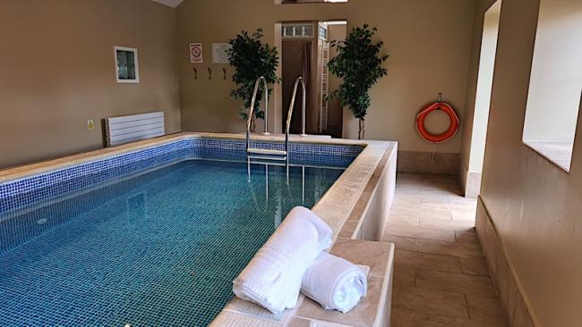 The indoor heated swimming pool in its own pool house.