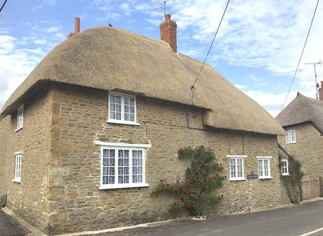 A 2-storey, thatched Dorset holiday cottage on a quiet village street.