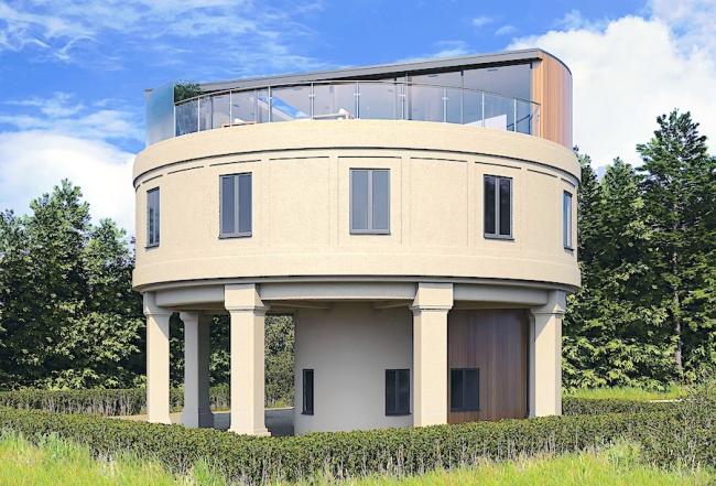 A water tower converted to a holiday home overlooks woods and fields.