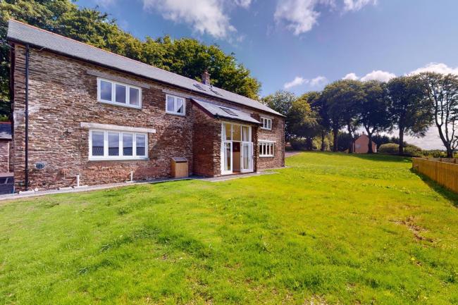 A Devon barn conversion overlooks a securely-fenced spacious lawn.