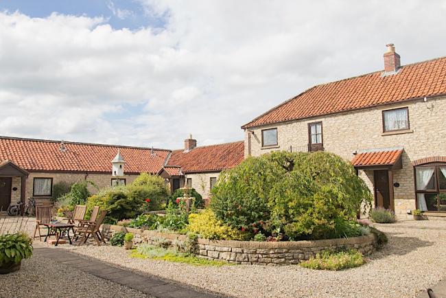 Exterior of a barn conversion overlooking a garden courtyard