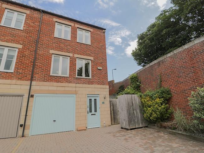 3-storey exterior of a Whitby holiday home with a garage on the ground floor