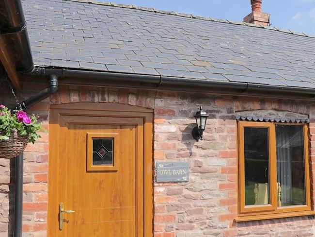Exterior of a slate-roofed, single-storey barn conversion in Leominster.