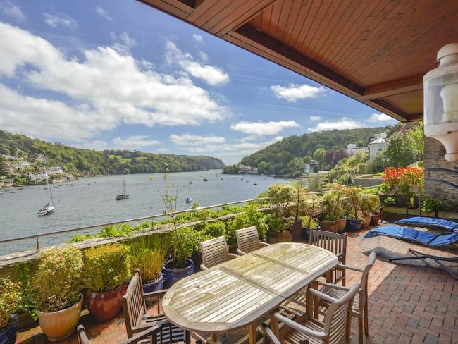 A view of Dartmouth estuary seen from the covered terrace of a waterside holiday let