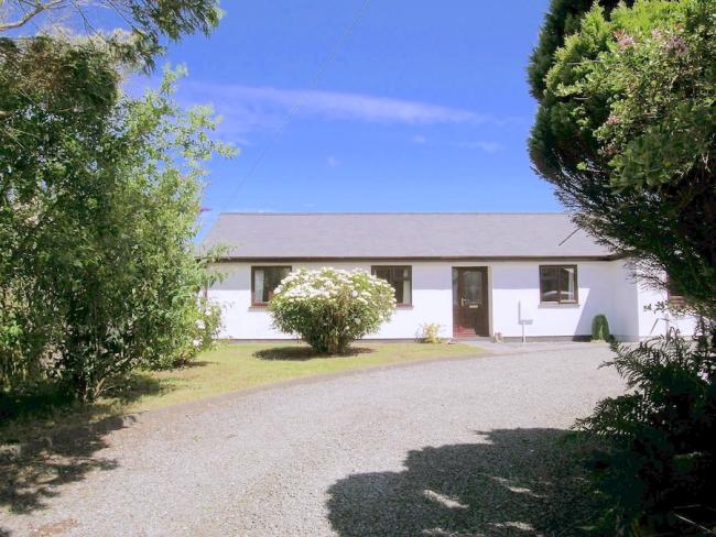 A wide tree-lined drive leads to a long, Boscastle holiday bungalow.