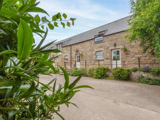 Exterior of a semi-detached, stone-built Alnwick barn conversion 