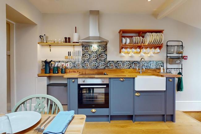 A contemporary Exmoor kitchen with a modern electric cooker and stylish pine top units.
